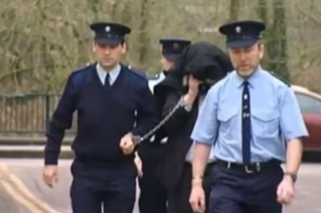 McGrath being led away from court during the murder case of Sylvia Roche Kelly.