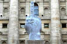 Italian artist unveils 20 foot middle finger to stock exchange