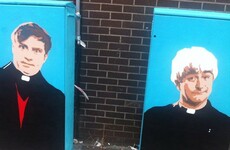 Someone has painted Ted and Dougal on these traffic boxes near Connolly Station