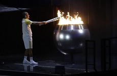 The man robbed of glory by an Irish priest 12 years ago lit the Olympic flame tonight