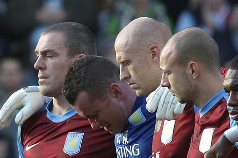 Shay Given and his Aston Villa teammates during the minute's silence for Gary Speed on Sunday. The inquest into his death opens today.