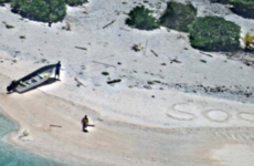 Two men washed up on uninhabited Pacific island saved after writing 'SOS' in the sand