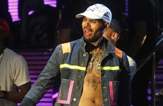 Chris Brown keeps posting videos online as police wait outside