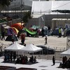 Thousands flee after fire started in Greek migrant camp