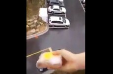 This woman effortlessly throwing her husband's lunch into his car from a balcony is #goals