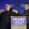 Donald Trump bundled off the stage at rally over gun scare