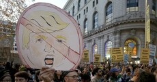 Protesters light fires in streets and block traffic in response to Trump's shock election