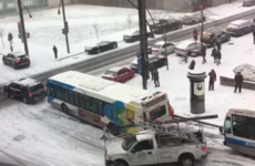 Watch as buses, a police car and a salt truck pile up on an icy Canadian hill