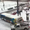Watch as buses, a police car and a salt truck pile up on an icy Canadian hill