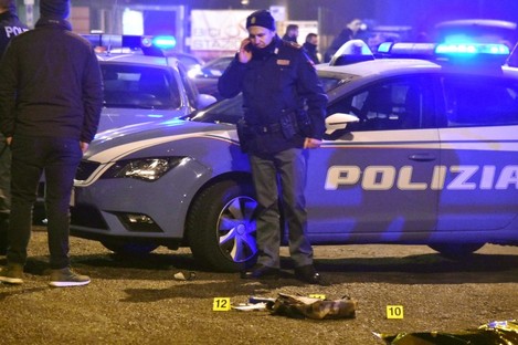 Police at the scene in Milan where the suspect was shot dead.