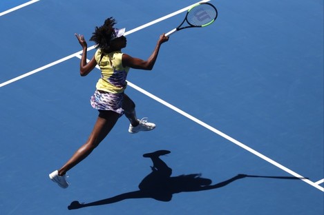 United States' Venus Williams makes a forehand return to Switzerland's Stefanie Voegele.