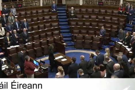 Members of the Dáil standing for the Dáil prayer. 