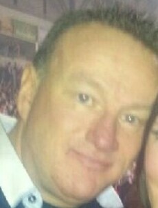 Woman arrested and police call for calm after 'reckless' murder of prominent loyalist