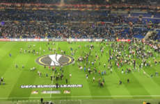 Violent clashes forced fans on the pitch and delayed Lyon's Europa League tie against Besiktas