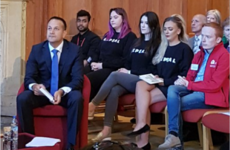 A photo of 3 women in Repeal jumpers defiantly sitting behind Leo Varadkar in Belfast has gone viral