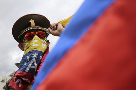 An anti-government demonstrator wearing a Russian military hat protests the government of Venezuela's President Nicolas Maduro in Caracas.