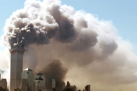Clouds of smoke rise from the burning upper floors of the World Trade Center in New York on 11 September 2001 