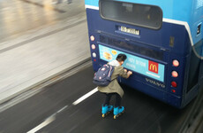 'Bus drivers were beeping wildly': Video captures rollerblader hitching ride on back of Dublin Bus