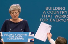 Comedian hands Theresa May a P45 during her Tory conference speech
