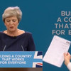 Comedian hands Theresa May a P45 during her Tory conference speech