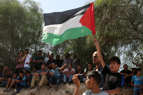 Palestinians celebrate as they wait for the arrival of Palestinian Prime Minister Rami Hamdallah and his government to take control of Gaza from the Islamist Hamas group.