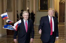 Trump gives thumbs-up to protester shouting 'Trump is treason' while throwing Russian flags at him