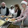 Volunteers will feed 3,500 poor and homeless people a Christmas dinner today