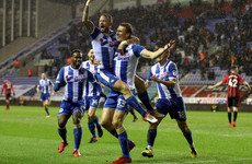 Third-tier Wigan stun Bournemouth as Swansea also progress in FA Cup