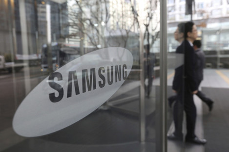 An employee walks past a logo of the Samsung Electronics Co. at its office in Seoul, South Korea.