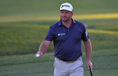 Graeme McDowell tied for the lead at Riviera while Tiger Woods misses cut
