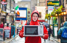 A DIT student is hitch-hiking through all 32 counties carrying a microwave for a really good cause