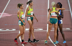Australian athletes wait nearly four minutes to hug the last-place finisher in the 10,000m