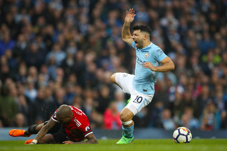 Aguero is caught late by Man United's Ashley Young during the recent derby. 