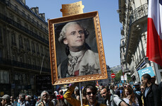 Thousands throng streets of Paris in protest against President Emmanuel Macron