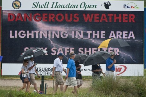 Patrons head for cover during a lightning delay in yesterday's Shell Houston Open first round.