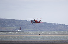 Coast Guard helicopter rescues woman and her dog cut off by the tide