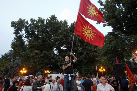 A man waves the former national flags during a protest in Skopje, Macedonia.