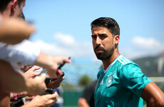 Swedish journalist hands Sami Khedira a boarding pass for early flight home