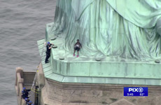 Woman arrested after scaling Statue of Liberty to protest US immigration policy