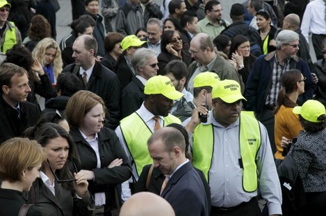 Members of the evacuation team stand among other office workers after 2 World Financial Center was briefly evacuated in New York.