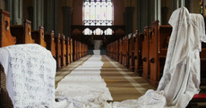 Names of 796 Tuam Babies written on white sheets and brought to Galway church