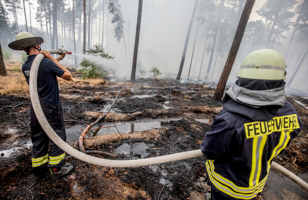 German firefighters stop spread of huge blaze but warn of ongoing threat