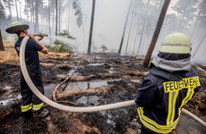 German firefighters stop spread of huge blaze but warn of ongoing threat