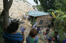 Rescuers frantically dig for survivors as death toll rises after landslide in the Philippines