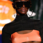 Italian designer says the use of 'three-breasted' models was a political statement