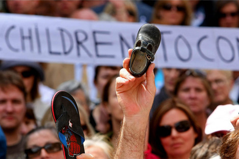 A child's shoe is held up as thousands of victims of institutional abuse survivors during the silent demonstrations in memory of the victims in Dublin city centre to the Dail in 2009.