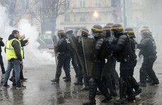 Paris police use tear gas and water cannon on anti-Macron tax protesters