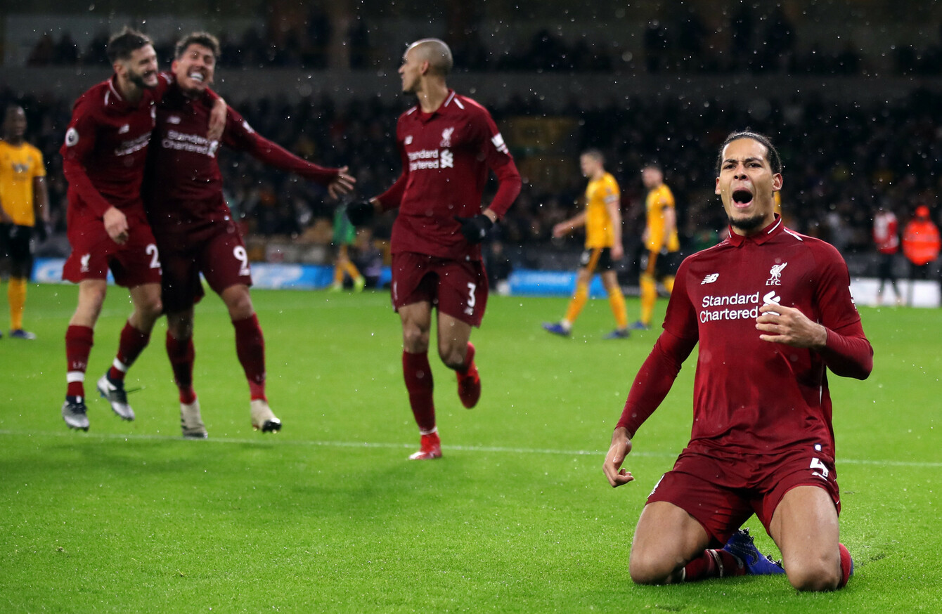  Liverpool players Mohamed Salah, Virgil van Dijk and Trent Alexander-Arnold celebrate a goal during a match at Molineux Stadium.