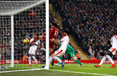 Salah scores landmark goal as Liverpool survive scare to extend lead at top