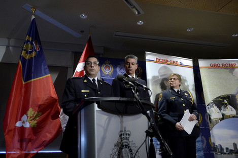 Officers answer questions from reporters after RCMP charged a youth with terrorism, in Kingston, Ontario